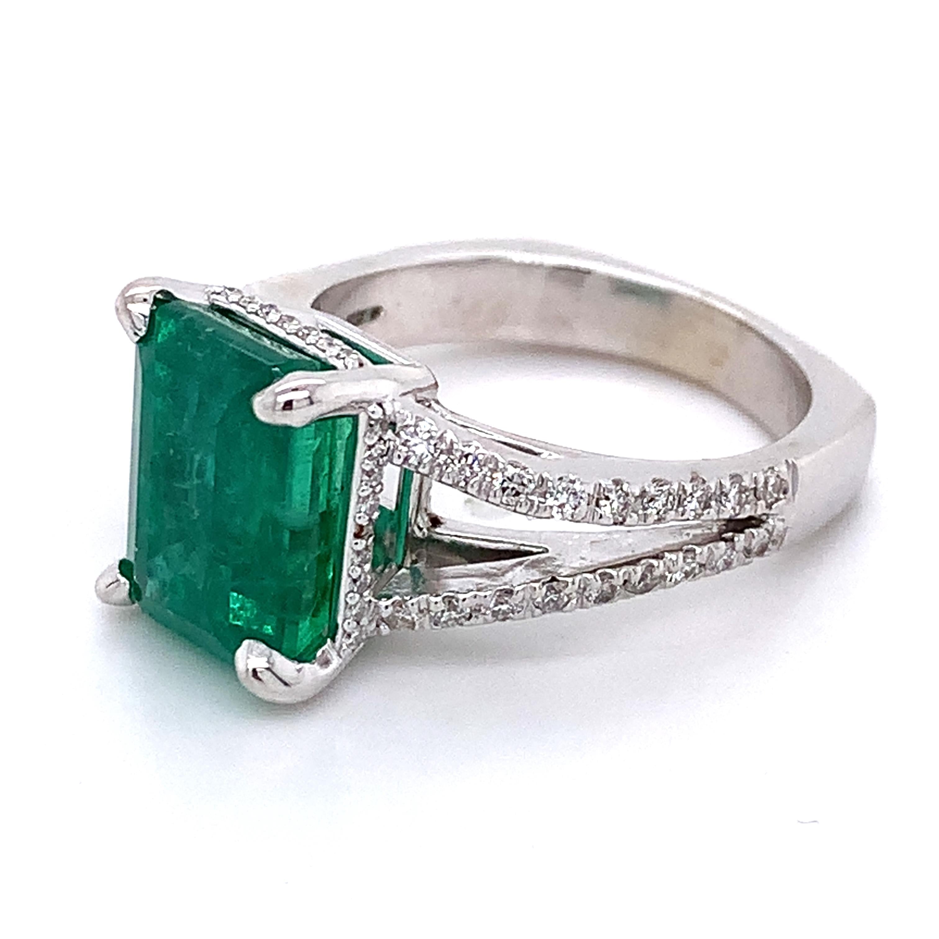 14K White Gold Emerald and Round Diamond Split Shank Open Cathedral Ring