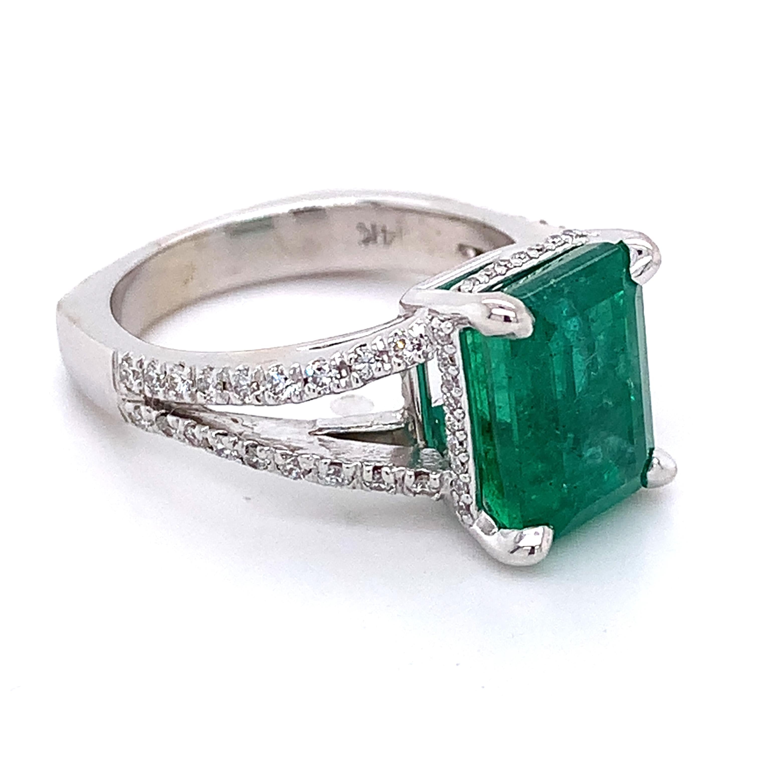 14K White Gold Emerald and Round Diamond Split Shank Open Cathedral Ring